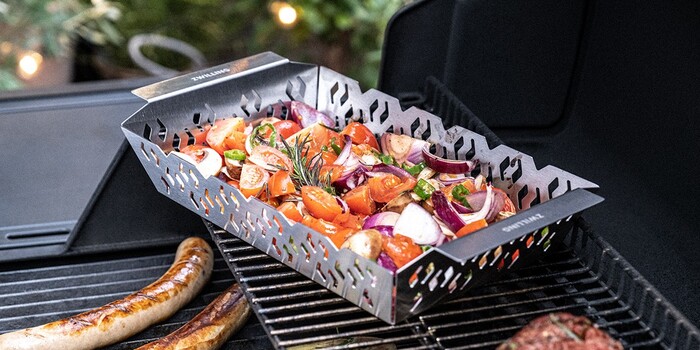 A vibrant setup featuring Mexican grilling tools, fresh tacos, and sizzling meats on a colorful outdoor grill station.