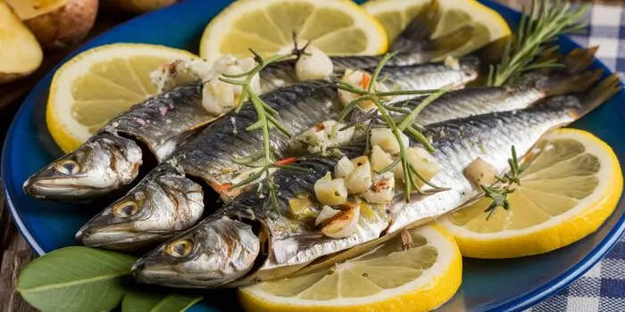 Plate of prepared sardines with garnishes, showcasing delicious and simple sardine recipe ideas.