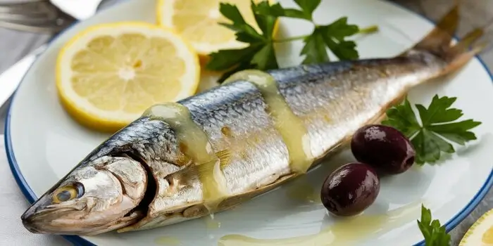 Deliciously prepared sardines on a plate, offering tips and recipes to enhance their flavor.